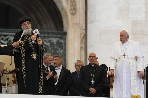 Pope Francis, right, starts his weekly audience in St. Peter's Square in the Vatican with the head of the Coptic Orthodox Church in Alexandria, Tawadros II, Wednesday, May 10, 2023. (AP Photo/Alessandra Tarantino)
