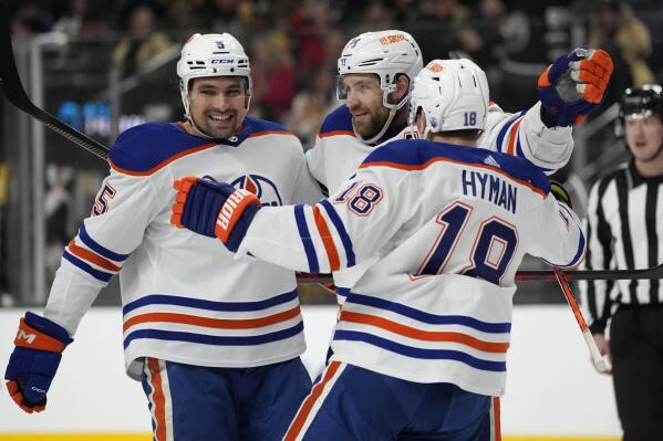 Edmonton Oilers center Leon Draisaitl, center, celebrates after scoring against the Vegas Golden Knights during the first period of an NHL hockey game Saturday, Jan. 14, 2023, in Las Vegas. (AP Photo/John Locher)