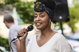 FILE - This file photo shows Camille Bennett, founder of Project Say Something, speaking outside the Lauderdale County Courthouse in Florence, Ala., on Friday, June 18, 2021. Bennett and the organization have filed suit claiming the city is trying to limit its protests over a Confederate monument. (Dan Busey/The TimesDaily via AP)