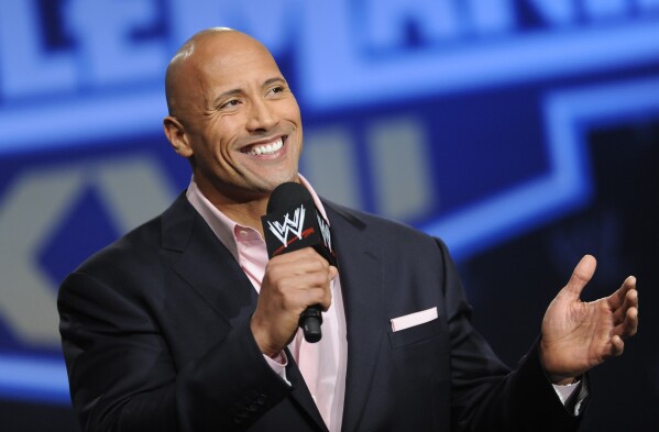 FILE - Actor and former WWE Superstar Dwayne "The Rock" Johnson participates in a Wrestlemania XXVII press conference at the Hard Rock Cafe in Times Square on Wednesday, Mar. 30, 2011 in New York. It is a name that has become almost synonymous with professional wrestling but its bearer, Dwayne Johnson, has never legally owned “The Rock.” That will change under a new agreement with the WWE under whichJohnson will also join the board of TKO Group, the sports and entertainment company that houses WWE and UFC.(AP Photo/Evan Agostini, file)