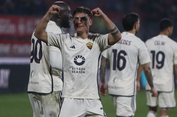 Roma's Paulo Dybala, centre, celebrates after scoring his side's third goal during the Serie A soccer match between AC Monza and Roma at the U-Power stadium in Monza, Italy, Saturday, March 2, 2024. (Alberto Mariani/LaPresse via AP)