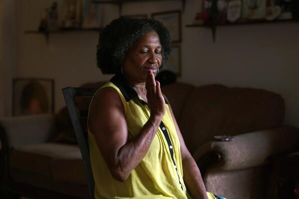 Michael Williams' wife Jacqueline Anderson reacts during an interview on Tuesday, July 27, 2021, in Chicago. When her husband was in jail, she pleaded with him to remember their fishing trips with the grandchildren, how he used to braid her hair, anything to jar him back to his world outside the concrete walls of Cook County Jail. (AP Photo/Charles Rex Arbogast)