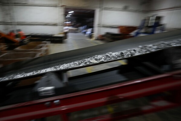 Materials from solar panels make their way along a sorting machine as the panels are recycled at We Recycle Solar on Tuesday, June 6, 2023, in Yuma, Ariz. (AP Photo/Gregory Bull)