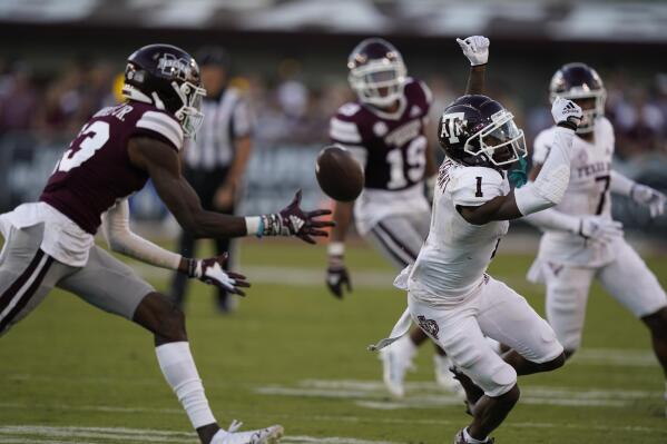 Texas A&M wide receiver Evan Stewart (1) looses a pass as Mississippi State cornerback Emmanuel Forbes reaches in to intercept during the second half of an NCAA college football game in Starkville, Miss., Saturday, Oct. 1, 2022. (AP Photo/Rogelio V. Solis)