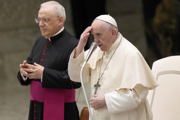 Pope Francis, flanked by Mons. Leonardo Sapienza, left, makes the sign of the cross during his weekly general audience in the Paul VI hall, at the Vatican, Wednesday, Sept. 8, 2021. (AP Photo/Andrew Medichini)