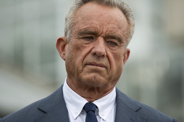 Health and Human Services Secretary Robert F. Kennedy Jr., left, following a tour of the Texas A&M AgriLife Phenotyping Greenhouse in College Station, Texas on Tuesday, April 29, 2025.(Meredith Seaver /College Station Eagle via AP)