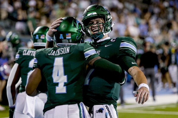 Tulane wide receiver Jha'Quan Jackson (4) and quarterback Michael Pratt (7) celebrate after a touchdown against South Alabama during the second half of an NCAA college football game in New Orleans, Saturday, Sept. 2, 2023. (AP Photo/Derick Hingle)
