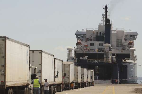 Trucks line up to be loaded into the Blue Wave Ferry during the inaugural trip between El Salvador and Costa Rica, at the port in La Union, El Salvador, Thursday, Aug. 10, 2023. The ferry service between El Salvador and Costa Rica began Thursday. (AP Photo/Salvador Melendez)