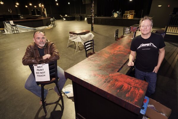 Dave Brown, left, and Mike Grimes, co-owners of The Basement East, pose inside the rebuilt music venue Thursday, Feb. 25, 2021, in Nashville, Tenn. The building was destroyed by a tornado March 3, 2020, and the difficulties of reopening were compounded by COVID-19. Now, as the anniversary of the two catastrophic events approaches, the owners hope to reopen their doors, this time with masks and tables spread out throughout their 5,000 square foot space. Amid signs that the virus is slowing its spread and more people are getting vaccines, they've set their sights on spring. (AP Photo/Mark Humphrey)