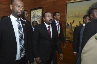 FILE - In this Sunday, Feb. 9, 2020, file photo, Ethiopia's Prime Minister Abiy Ahmed, center, arrives for the opening session of the 33rd African Union (AU) Summit at the AU headquarters in Addis Ababa, Ethiopia. Ethiopia's prime minister on Wednesday, Nov. 4, 2020 ordered the military to confront the Tigray regional government after he said it attacked a military base overnight, citing months of "provocation and incitement" and declaring that "the last red line has been crossed." (AP Photo, File)