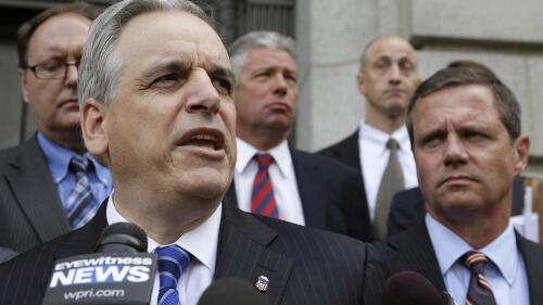 FILE - U.S. Attorney Peter Neronha, front left, responds to questions from reporters outside federal court, June 11, 2015, in Providence, R.I. A major Rhode Island landlord whose tenants have long complained about lead hazards, rodent infestations and other problems was sued Tuesday, June 6, 2023 by the state attorney general, Peter Neronha, who said conditions at many of the properties put renters' health and safety at risk. (AP Photo/Steven Senne, file)