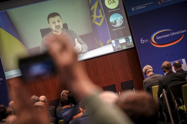 Ukrainian President Volodymyr Zelenskyy speaks during a live broadcast at the 6th German-Ukrainian Business Forum of the DIHK, the Committee on Eastern European Economic Relations and the German-Ukrainian Chamber of Industry and Commerce (AHK Ukraine), in Berlin, Tuesday, Oct. 24, 2023. Topics include infrastructure, energy and defense as well as investment conditions for German companies in Ukraine. (Kay Nietfeld/dpa via AP)