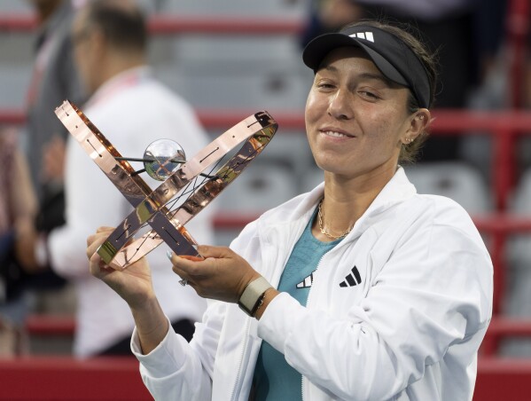Jessica Pegula, of the United States, holds the trophy following her win over Liudmila Samsonova, of Russia, in the final of the women's National Bank Open tennis tournament in Montreal, Sunday, Aug. 13, 2023. (Christinne Muschi/The Canadian Press via AP)