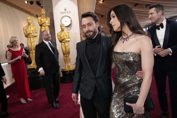 Kieran Culkin, left, and Jazz Charton arrive at the Oscars on Sunday, March 2, 2025, at the Dolby Theatre in Los Angeles. (AP Photo/John Locher)