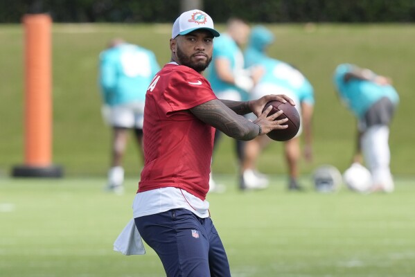 Miami Dolphins quarterback Tua Tagovailoa (1) aims the ball during a practice session at the team's training facility, Wednesday, Oct. 23, 2024, in Miami Gardens, Fla. (AP Photo/Marta Lavandier)