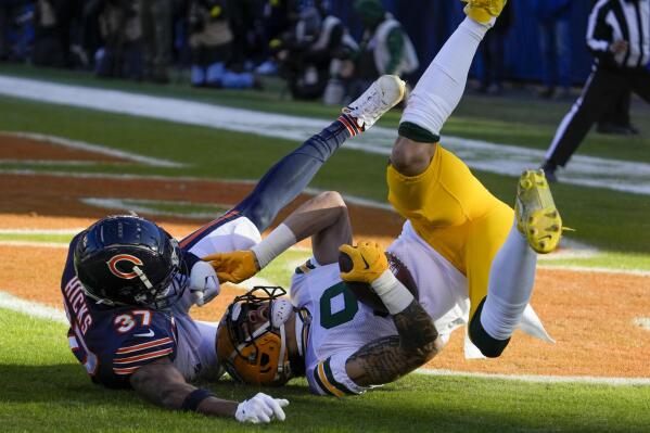 Green Bay Packers' Christian Watson catches a touchdown pass with Chicago Bears' Elijah Hicks defending during the first half of an NFL football game Sunday, Dec. 4, 2022, in Chicago. (AP Photo/Nam Y. Huh)