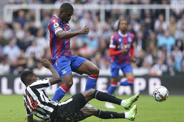 Newcastle United's Alexander Isak, below, challenges Crystal Palace's Cheick Doucoure during the English Premier League soccer match between Newcastle United and Crystal Palace at St. James' Park, Newcastle, Saturday, Sept. 3, 2022. (Owen Humphreys/PA via AP)