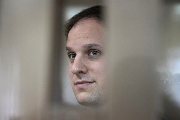 FILE - Wall Street Journal reporter Evan Gershkovich stands in a glass cage in a courtroom at the Moscow City Court in Moscow, Russia, Oct. 10, 2023. (AP Photo/Alexander Zemlianichenko, File)