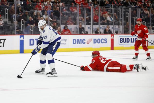 Tampa Bay Lightning left wing Alex Killorn, left, breaks away from Detroit Red Wings left wing David Perron (57) for an empty-net goal during the third period of an NHL hockey game, Saturday, Feb. 25, 2023, in Detroit. (AP Photo/Al Goldis)