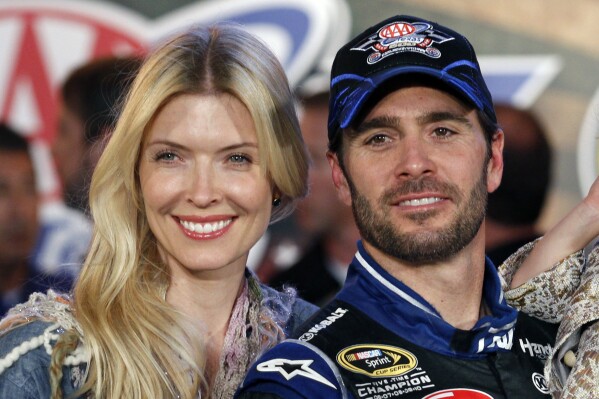 FILE - Jimmie Johnson poses with his wife Chandra Janway in victory lane after his win in a NASCAR Sprint Cup Series auto race at Texas Motor Speedway in Fort Worth, Texas, Nov. 4, 2012. Police in Muskogee, Okla., confirmed Tuesday, June 27, 2023, that they are investigating the deaths of three relatives of seven-time NASCAR champion Johnson as an apparent murder-suicide. A representative for Johnson confirmed the three are the parents and nephew of Johnson's wife, Chandra Janway. (AP Photo/Tim Sharp, File)