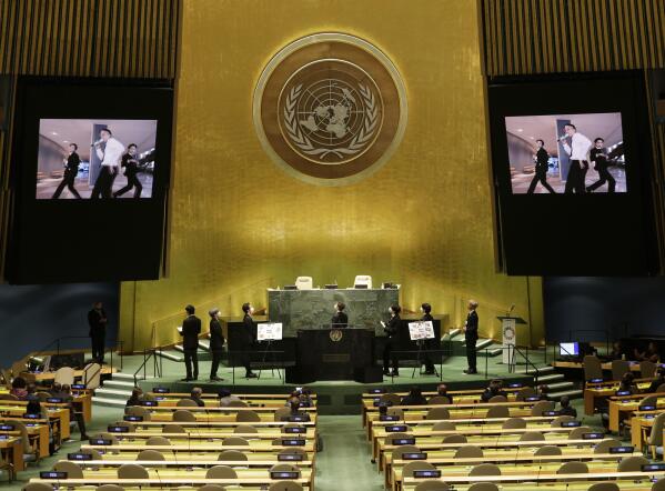 Members of South Korean K-pop band BTS watch a music video on the General Assembly Hall monitors during a meeting on Sustainable Development Goals at the 76th session of the U.N. General Assembly at U.N. headquarters on Monday, Sept. 20, 2021. In his General Assembly opening address on Tuesday, U.N. Secretary-General Antonio Guterres practically scolded world leaders for disappointing young people with a perceived inaction on climate change, inequalities and the lack of educational opportunities, among other issues important to young people. (John Angelillo/Pool Photo via AP)