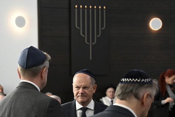 German Chancellor Olaf Scholz speaks with John Crosby, left, U.S. Consul General for Saxony, Saxony-Anhalt and Thuringia, during the inauguration of the newly built synagogue in Dessau, Germany, Sunday, Oct. 22, 2023. Scholz said Germany will do everything to protect and strengthen Jewish life in his remarks at the inauguration of the Weill Synagogue in Dessau. (Hendrik Schmidt/Pool Photo via AP)
