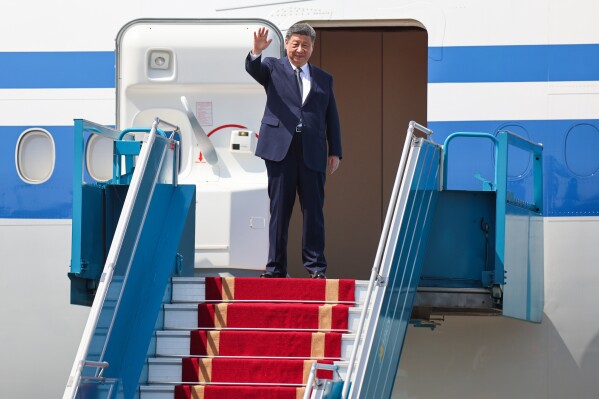 Chinese President Xi Jinping waves as he boards his plane for departure at Noi Bai International Airport in Hanoi, Vietnam Tuesday, April 15, 2025. (Athit Perawongmetha/Pool Photo via AP)