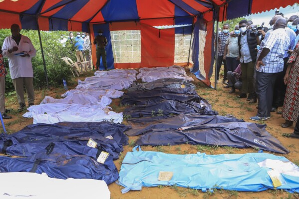 FILE - Body bags are laid out at the scene where dozens of bodies have been found in shallow graves in the village of Shakahola, near the coastal city of Malindi, in southern Kenya on April 24, 2023. The number of people who died in connection with Kenya’s doomsday cult has crossed the 400 mark as detectives exhumed 12 more bodies on Monday, July 18, 2023, believed to be followers of a pastor who ordered them to fast to death in order to meet Jesus. Pastor Paul Mackenzie, who is linked to the cult based in a forested area in Malindi, coastal Kenya, is in police custody, along with 36 other suspects. All have yet to be charged. (AP Photo)