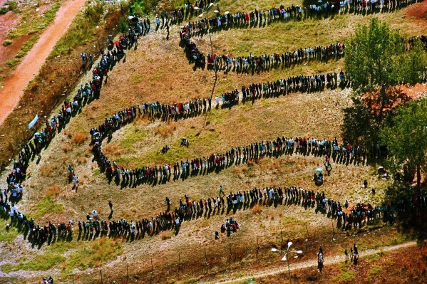 FILE - People queue to cast their votes In Soweto, South Africa April 27, 1994, in the country's first all-race elections. (AP Photo/Denis Farrell. File)