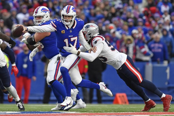Buffalo Bills quarterback Josh Allen is sacked by New England Patriots linebacker Josh Uche during the second half of an NFL football game in Orchard Park, N.Y., Sunday, Dec. 31, 2023. (AP Photo/Adrian Kraus)