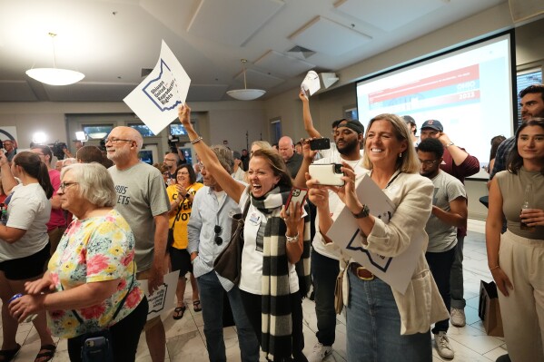 People celebrate the defeat of Issue 1 during an election night party at the Columbus Fire Fighters Local 67 on Tuesday, Aug. 8, 2023 in Columbus, Ohio. Ohio voters have rejected a proposal that would've made it more difficult for voters to amend the state constitution, including one measure set for the November ballot that would guarantee abortion rights in the state. (Adam Cairns/The Columbus Dispatch via AP)