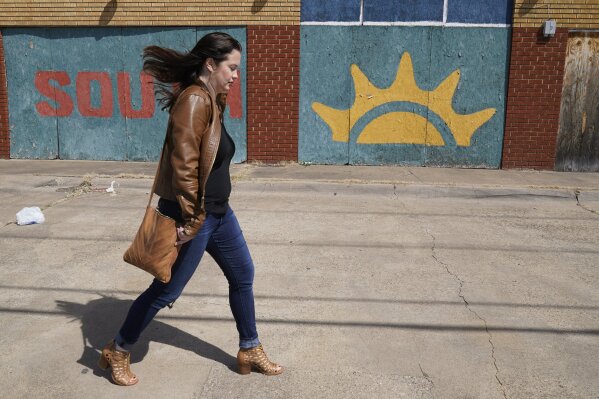 Keri Mitchell, executive editor of the Dallas Free Press, walks on Malcom X Blvd in south Dallas, Monday, March 8, 2021. Mitchell submitted records requests to the Dallas school district that took months to resolve because of the pandemic. The Dallas Independent School District suspended all records requests for seven months while its employees were working from home with laptop computers. "If we can't get timely responses to open-records requests, we can't get people actual answers," Mitchell said. "It just creates another barrier to the information people need to literally survive." (AP Photo/LM Otero)