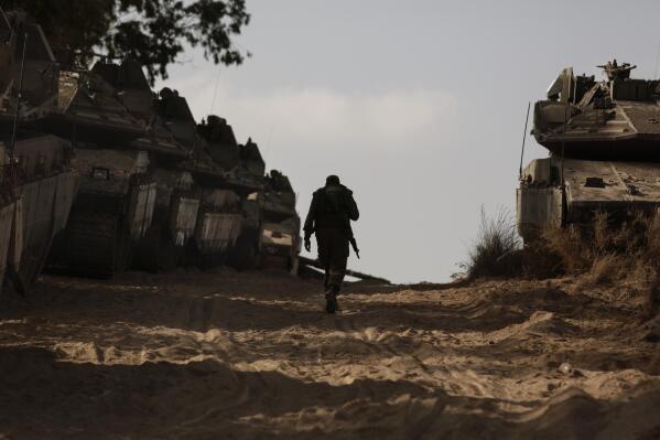 An Israeli soldier walks at a staging ground near the border with the Gaza Strip, in southern Israel, Thursday, May 20, 2021. (AP Photo/Maya Alleruzzo)