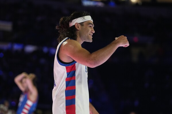 NFL wide receiver Puka Nacua celebrates during the second half of the NBA basketball All-Star Celebrity Game, Friday, Feb. 16, 2024, in Indianapolis. (APPhoto/Darron Cummings)