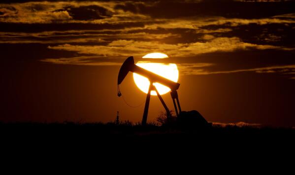 FILE - In this Wednesday, April 8, 2020 file photo, the sun sets behind an idle pump jack near Karnes City, USA. The OPEC oil cartel and allied countries are meeting to decide on production. The meeting is being closely watched because oil markets are tight and the price of crude is just off a three-year high as the global economy bounces back from the pandemic. (AP Photo/Eric Gay, File)