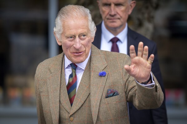 FILE - Britain's King Charles III waves during his visit to the Discovery Centre and Auld School Close to hear more about the 3.3million pound (4.1 million US dollars) energy efficient housing project in the area, in Tomintoul, Scotland, Wednesday, Sept. 13, 2023. Buckingham Palace announced Wednesday, Oct. 11, 2023, that King Charles III will travel to Kenya later this month for a state visit full of symbolism: His mother, the late Queen Elizabeth II, learned she had become queen while visiting a game preserve in the East African nation in 1952. (Jane Barlow/Pool Photo via AP, File)