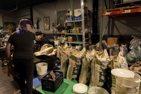 Renee Colon, co-owner of Fuego Coffee Roasters, works at her roasting facility Friday, March 21, 2025, in Rochester, N.Y. (Max Conway via AP)