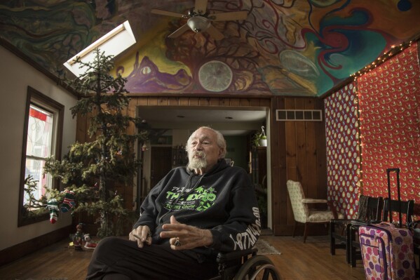 FILE - John Sinclair talks at the John Sinclair Foundation Café and Coffeeshop, Dec. 26, 2018, in Detroit. Sinclair, a poet, music producer and counterculture figure whose lengthy prison sentence after a series of small-time pot busts inspired a John Lennon song and a star-studded 1971 concert to free him, has died at age 82. Sinclair died Tuesday, April 2, 2024 at Detroit Receiving Hospital of congestive heart failure following an illness, his publicist Matt Lee said. (Junfu Han/Detroit Free Press via AP, File)