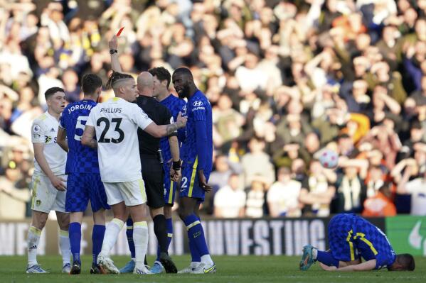 Leeds United's Daniel James, left, receives a red card during the English Premier League soccer match between Leeds United and Chelsea at Elland Road in Leeds, England, Wednesday May 11, 2022. (AP Photo/Jon Super)
