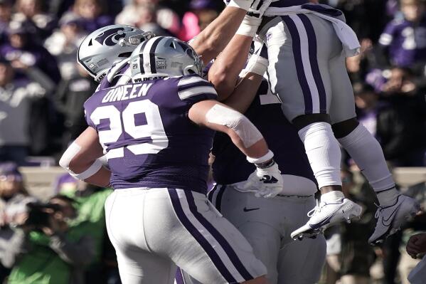 Kansas State running back Joe Ervin (20) celebrates with teammates after scoring a touchdown during the first half of an NCAA college football game against West Virginia, Saturday, Nov. 13, 2021, in Manhattan, Kan. (AP Photo/Charlie Riedel)