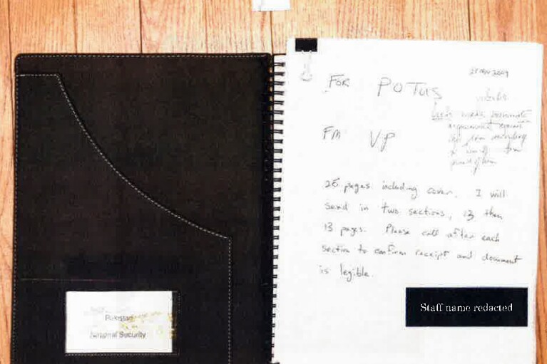 This image, contained in the report from special counsel Robert Hur, shows the "Af/Pak 1" notebook with a Thanksgiving 2009 memo from Biden to President Barack Obama, found in a file cabinet under a television in President Joe Biden's first- floor home office in Wilmington, Del., on Jan. 20, 2023, during a search by FBI agents. (Justice Department via AP)