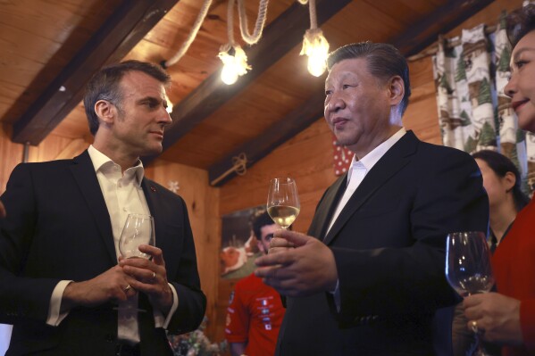 Chinese President Xi Jinping and his wife Peng Liyuan, right, enjoy a drink with French President Emmanuel Macron in a restaurant, Tuesday, May 7, 2024 at the Tourmalet pass, in the Pyrenees mountains. French president is hosting China's leader at a remote mountain pass in the Pyrenees for private meetings, after a high-stakes state visit in Paris dominated by trade disputes and Russia's war in Ukraine. French President Emmanuel Macron made a point of inviting Chinese President Xi Jinping to the Tourmalet Pass near the Spanish border, where Macron spent time as a child visiting his grandmother. (AP Photo/Aurelien Morissard, Pool)