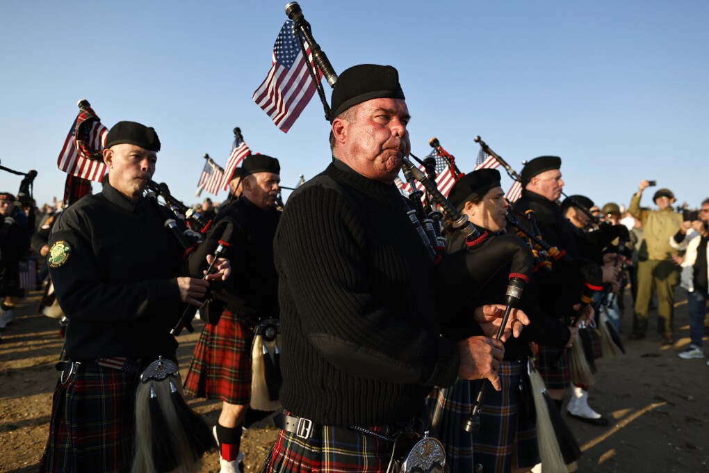 A pipe band plays during a ceremony at Utah Beach near Saint-Martin-de-Vareville Normandy, Thursday, June 6, 2024. World War II veterans from across the United States as well as Britain and Canada are in Normandy this week to mark 80 years since the D-Day landings that helped lead to Hitler's defeat. (AP Photo/Jeremias Gonzalez)