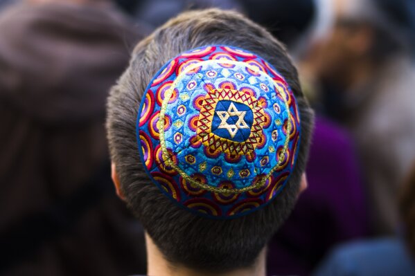 
              A man wears a Jewish skullcap, as he attends a demonstration against an anti-Semitic attack in Berlin, Wednesday, April 25, 2018. (AP Photo/Markus Schreiber)
            