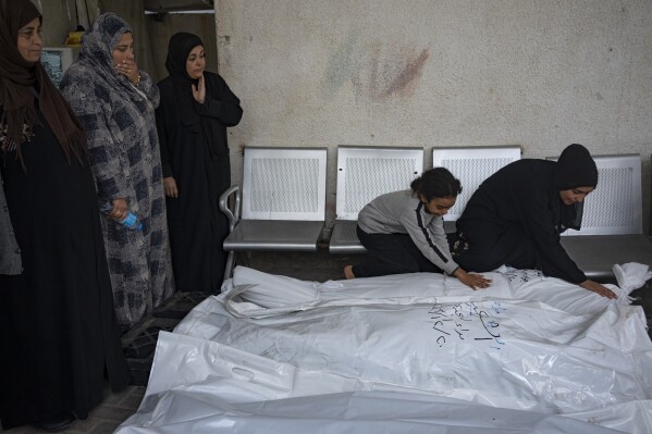 Palestinians mourn their relatives killed in the Israeli bombardment of the Gaza Strip, at the hospital Rafah, southern Gaza, Thursday, Dec. 21, 2023. (AP Photo/Fatima Shbair)