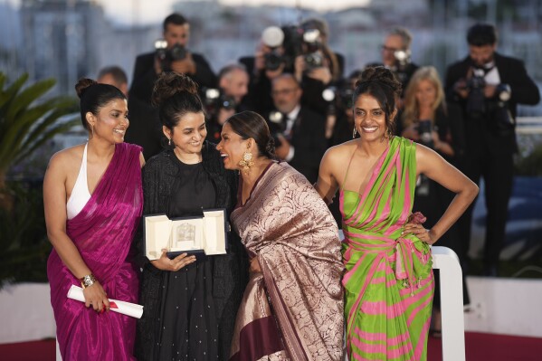 Payal Kapadia, second from left , winner of the grand prize for 'All We Imagine as Light,' poses with Divya Prabha, from left, Chhaya Kadam and Kani Kusruti during the photo call following the awards ceremony at the 77th international film festival, Cannes, southern France, Saturday, May 25, 2024. (Photo by Scott A Garfitt/Invision/AP)