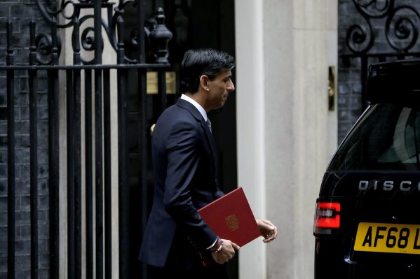 British Chancellor of the Exchequer Rishi Sunak leaves number 11 Downing Street, to deliver a financial announcement to the Houses of Parliament in London, Wednesday, July 8, 2020. British Treasury chief Rishi Sunak on Wednesday is set to announce a 2-billion-pound ($2.5 billion) program to create jobs for young people as the government tries to revive an economy battered by the COVID-19 pandemic. (AP Photo/Matt Dunham)