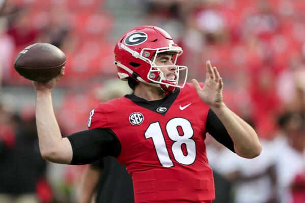 Georgia quarterback JT Daniels (18) warms up for the team's NCAA college football game against South Carolina on Saturday, Sept. 18, 2021, in Athens, Ga. (AP Photo/Butch Dill)
