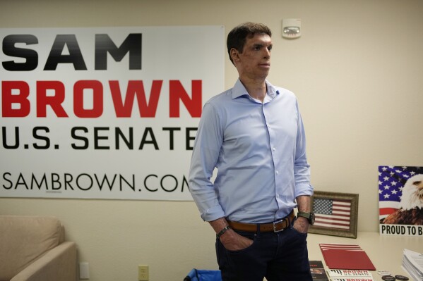 FILE - Nevada Republican Senate hopeful Sam Brown, a retired Army captain and Purple Heart recipient, stands in a campaign office Tuesday, June 14, 2022, in Las Vegas. Brown made his long-awaited U.S. Senate candidacy official on Monday, July 10, 2023, jumping into the race to take on Democratic incumbent Jacky Rosen a year after losing the Republican nomination to challenge Nevada's other U.S. senator. (AP Photo/John Locher, File)