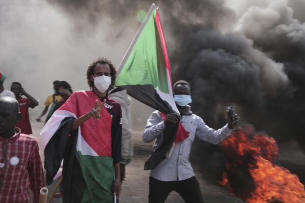 People take part in a protest against the October military takeover and a subsequent deal that reinstated Prime Minister Abdalla Hamdok but sidelined the movement in Khartoum, Sudan, Sunday, Dec. 19, 2021. (AP Photo/Marwan Ali)